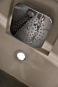 a shower head in the ceiling of a bathroom at Xi Hotel in Hong Kong