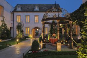 
a large outdoor patio with a large clock on the front of it at Hôtel Le Cep in Beaune
