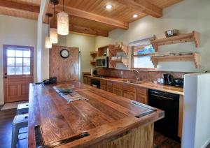 a large kitchen with a large wooden counter top at Abiquiu Inn in Abiquiu