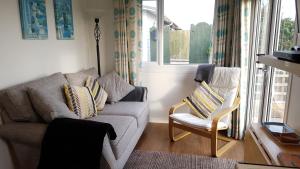 a living room with a couch and two chairs at For-Get-Me-Not Chalet semi detached in Bridlington