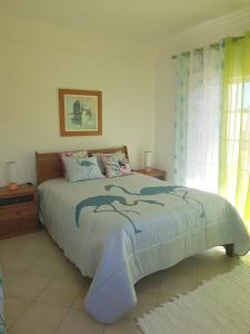 A bed or beds in a room at Vila apartamentos Estrela