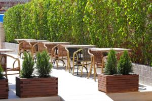 a row of tables and chairs in a patio at Nura Santa Ponsa & Spa in Santa Ponsa
