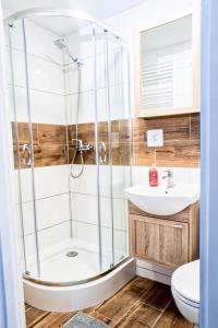a bathroom with a shower and a sink at Morning Star Apartments in Międzyzdroje