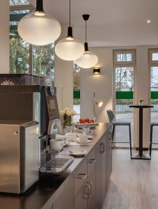 a kitchen with several lights and a counter with food at Hotel the YARD Bad Honnef in Bad Honnef am Rhein +23 photos
