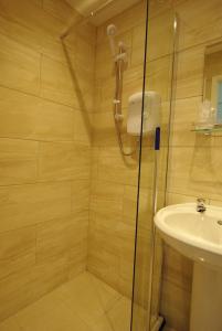 a bathroom with a shower and a sink at The Sandhill in Sandown