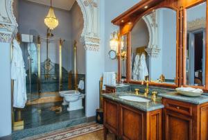 a bathroom with two sinks and a mirror at Relais & Chateaux Villa Crespi in Orta San Giulio