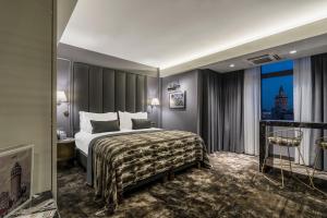 a hotel room with a bed and a window at Galata Times Hotel in Istanbul
