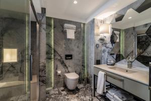 a bathroom with a sink and a toilet and a shower at Galata Times Hotel in Istanbul +48 photos