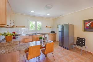 a kitchen with a refrigerator and a table and chairs at Villas Guzman - Bernia in Calpe