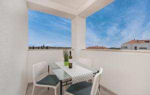 a table and chairs on a balcony with a window at Apartments Kimi in Rovinj