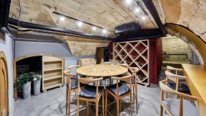 a dining room with a table and chairs and a brick wall at Wine and Pillow Hotel by Frapolli in Odesa