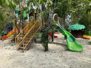 a playground with a green slide and a playground at 2 bedroom Apartment in Oasis in Chakvi