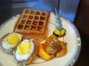 un plato de desayuno con huevos y gofres en A Mighty Oak B&B, en Pilot Mountain