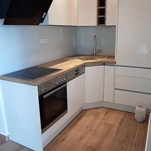 a small kitchen with a stove and a sink at Apartments Nika's View in Vodice +25 photos