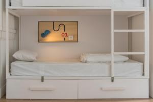 a bedroom with a bed and a dresser at Away Hostel & Coffee Shop in Lyon