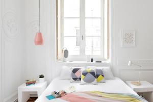 a white bedroom with a bed and a window at SLO Hostel Lyon les Pentes in Lyon +53 photos