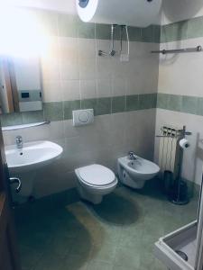 a bathroom with a toilet and a sink at Residence Redivalle in Passo del Tonale