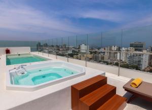 a hot tub on the roof of a building at Dazzler by Wyndham Lima San Isidro in Lima