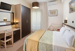Postel nebo postele na pokoji v ubytování Hotel Conchiglia