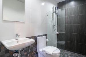 a bathroom with a toilet and a sink and a shower at PP GRAND KAMALA HOTEL-SHA Extra Plus in Kamala Beach +61 photos
