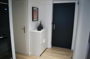 a room with a door and a table with a vase on it at Le 1777 in Dinan