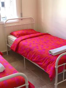 a bed with a red comforter in a room at First Floor Apartment Family Layout in Oued Laou +45 photos