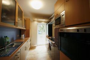 a kitchen with a sink and a stove top oven at Gästehaus Liemehna in Liemehna