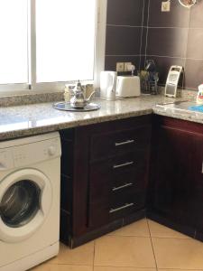 a kitchen with a washing machine and a sink at Oued Laou Sea View واد لاو in Oued Laou