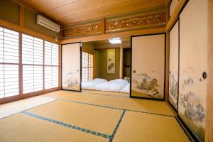 a japanese room with a bed in the corner at ID Stay Kawaguchiko in Fujikawaguchiko