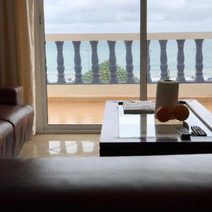 a living room with a table and a view of the ocean at Oued Laou Sea View واد لاو in Oued Laou