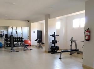 a gym with several exercise equipment in a room at Faro Armonía in Bajamar