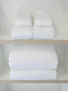 a stack of towels on a shelf in a bathroom at J.K. Mansion in Bangkok