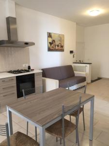 a kitchen and living room with a table and a couch at Acquamarina in Levanto