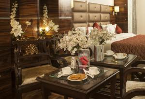 a hotel room with a bed and a table with cookies on it at Hotel Delhi 55 -City Center, New Delhi Railway Station, Paharganj in New Delhi