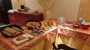 a table with bread and other food on it at Hotel Le Bon Laboureur in La Charité-sur-Loire