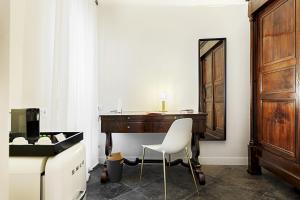 a room with a wooden table and a chair at A.D. 1768 Boutique Hotel in Ragusa