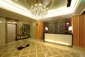 a lobby of a hotel with a chandelier at MRT Hotel in Taipei