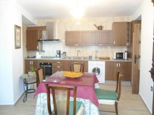 a kitchen with a table with a table cloth on it at Casa de Los Albas 4p in Montefrío