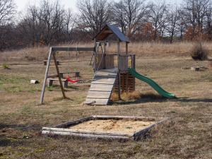 a playground with a slide in a field at A-Apartment in Krasnovo