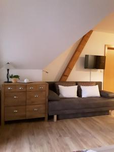 a living room with a couch and a dresser at Anna's Home - Ferienwohnungen in Ratsch an der Weinstraße
