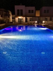 a large swimming pool lit up at night at Casa Zen in Puerto Calero
