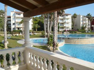 a view of the pool from the balcony of a resort at HG Jardín de Menorca in Son Bou