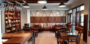 a restaurant with wooden tables and chairs and a bar at Platanos Rooms in Anopoli Sfakion