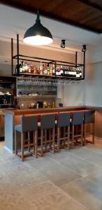 a bar in a restaurant with chairs and a counter at Platanos Rooms in Anopoli Sfakion