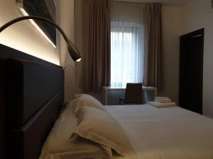 Posteľ alebo postele v izbe v ubytovaní Albergo Delle Alpi