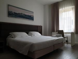 Posteľ alebo postele v izbe v ubytovaní Albergo Delle Alpi