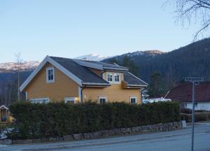 a house with a solar roof on the side of a street at Sandvik Garasjeloft in Vossevangen