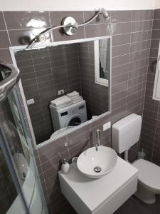 バルドリーノにあるCasa Robyのバスルーム(洗面台、トイレ、鏡付)