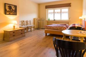 a bedroom with a bed and a table and chairs at Forsthaus Edelburg Ferienhaus in Hemer