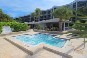 a swimming pool in front of a building at Coconut Palms in Key West